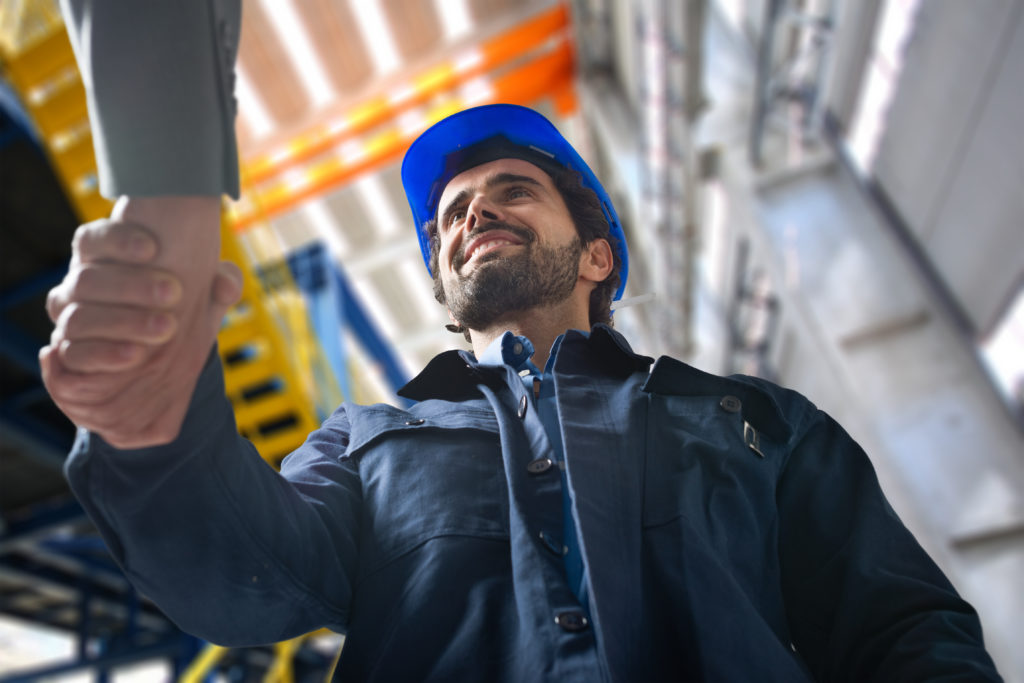 Portrait,Of,A,Man,Giving,An,Handshake,In,An,Industrial